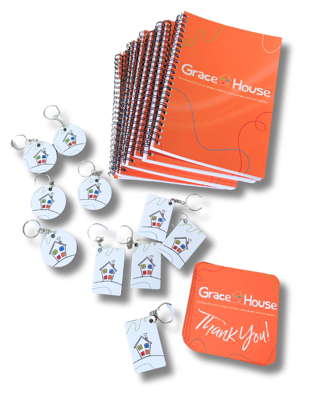 Branded notepads, coasters and keyrings which were produced by Refresh By G for the charity Grace House